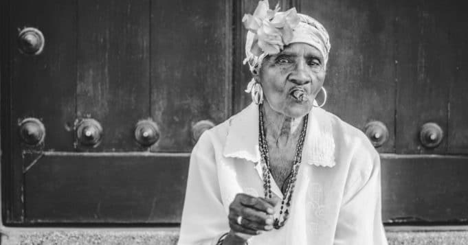 Elderly woman smoking tobacco