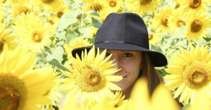Woman in sunflowers field