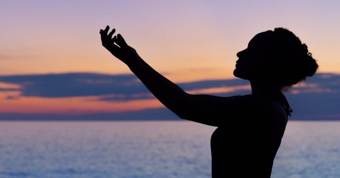 Woman spreading her hands to the sky